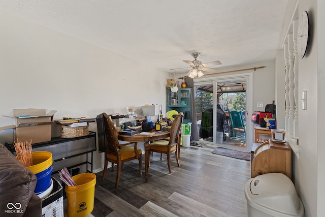 dining area with ceiling fan and wood finished floors