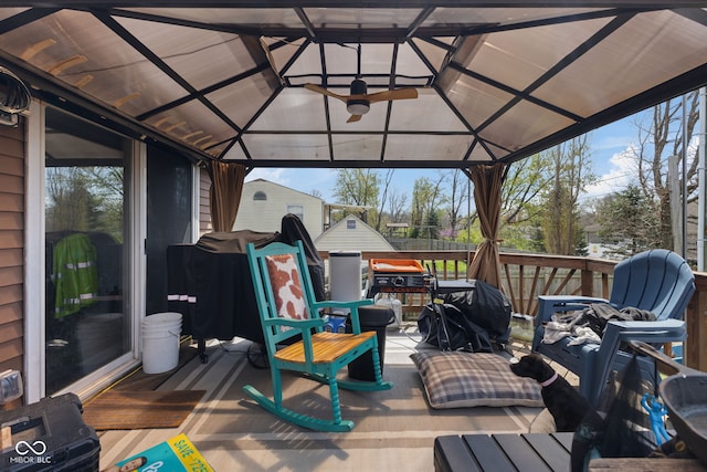 deck with a gazebo, an outbuilding, and a shed