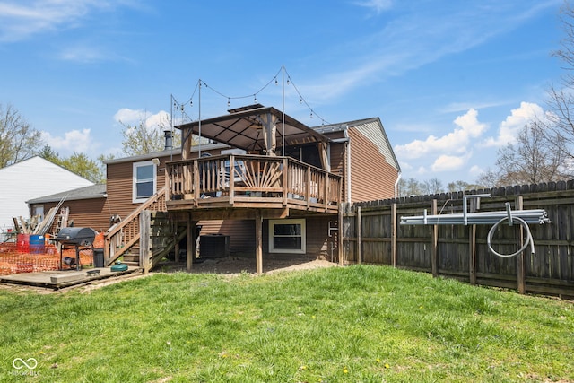 back of property with central AC, fence, a wooden deck, stairway, and a yard