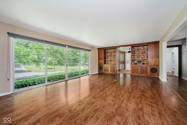 701 Hawthorn Rd, New Castle, IN 47362 - unfurnished living room featuring dark wood finished floors and baseboards