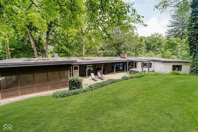 701 Hawthorn Rd, New Castle, IN 47362 - rear view of property featuring a chimney, a yard, a patio area, and a sunroom