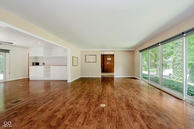 701 Hawthorn Rd, New Castle, IN 47362 - unfurnished living room with dark wood-type flooring and recessed lighting