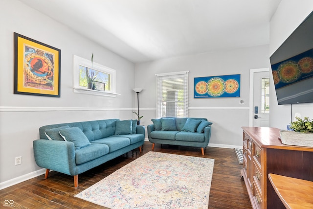 living area featuring dark wood-style flooring and baseboards