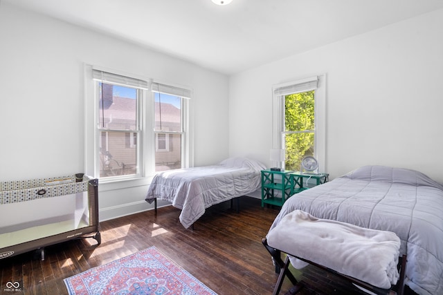bedroom featuring hardwood / wood-style flooring and baseboards