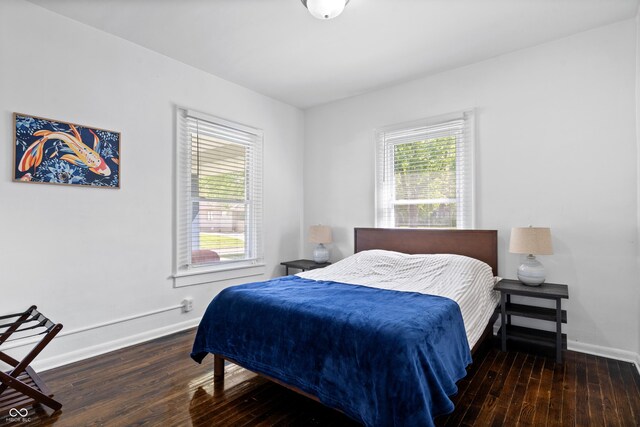 bedroom with hardwood / wood-style flooring and baseboards