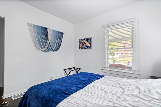 bedroom with dark wood-style floors and baseboards