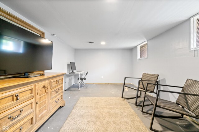 sitting room featuring concrete floors, plenty of natural light, an office area, and recessed lighting