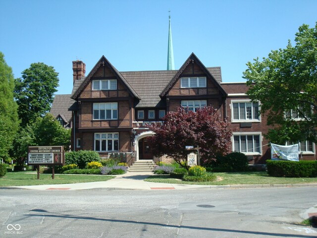 tudor house featuring a chimney