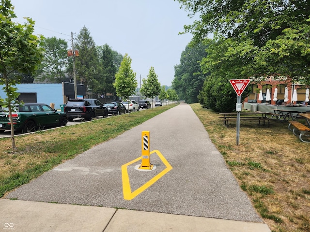 view of asphalt road featuring traffic signs