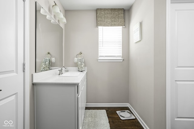 bathroom with vanity, baseboards, and wood finished floors