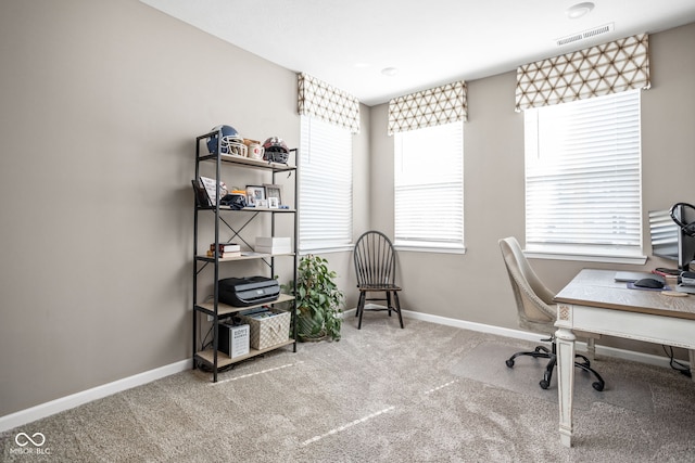 home office featuring carpet flooring, baseboards, and a healthy amount of sunlight