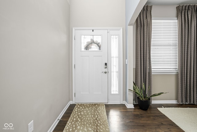 foyer entrance featuring dark wood-style flooring and baseboards