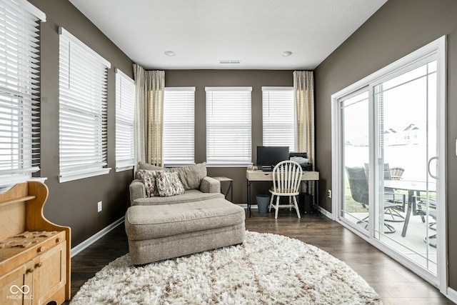 sitting room featuring visible vents, baseboards, and wood finished floors