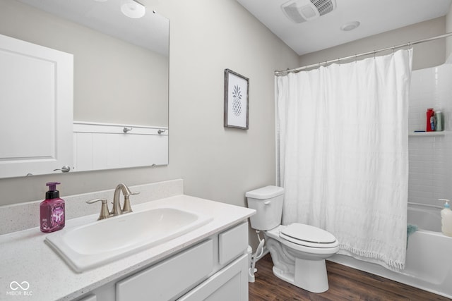 full bathroom featuring shower / tub combo with curtain, vanity, toilet, wood finished floors, and visible vents