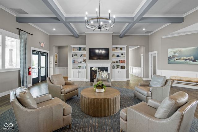living area featuring an inviting chandelier, beamed ceiling, coffered ceiling, and wood finished floors
