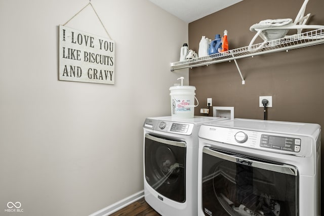 laundry area with separate washer and dryer, laundry area, dark wood finished floors, and baseboards