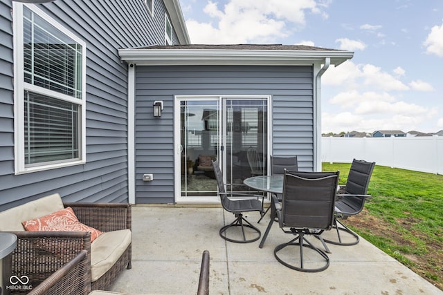 view of patio featuring fence and outdoor dining area