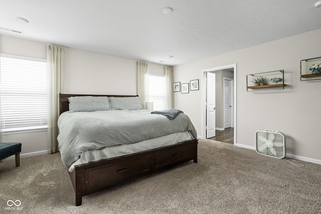 carpeted bedroom with visible vents and baseboards
