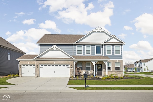 craftsman-style home featuring a porch, roof with shingles, a front yard, concrete driveway, and an attached garage