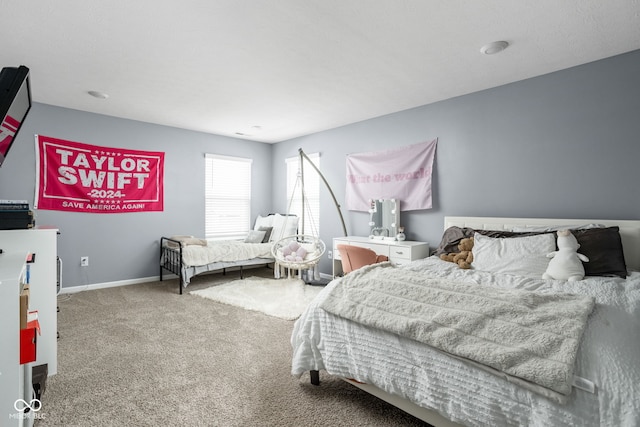 carpeted bedroom featuring baseboards