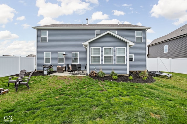rear view of property with a fenced backyard, a lawn, and a patio area