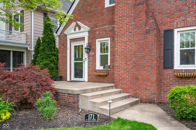 property entrance with brick siding