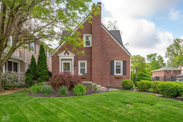 view of side of property featuring brick siding and a chimney