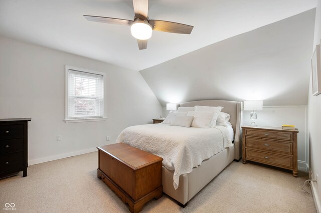 bedroom featuring light colored carpet, ceiling fan, lofted ceiling, and baseboards