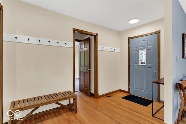 entryway featuring baseboards, visible vents, and light wood-style floors