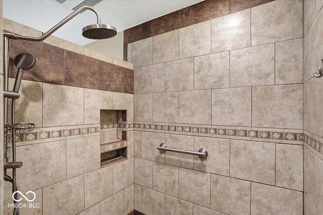 interior details featuring tiled shower