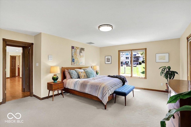 bedroom with baseboards, light colored carpet, and visible vents