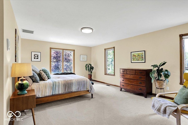 bedroom with carpet floors, baseboards, and visible vents