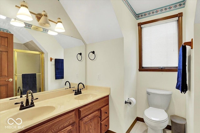 bathroom featuring double vanity, a sink, lofted ceiling, and a stall shower