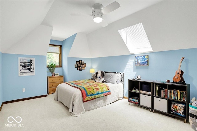 bedroom featuring baseboards, ceiling fan, carpet flooring, and lofted ceiling with skylight