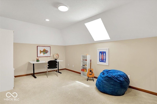 home office featuring vaulted ceiling with skylight, baseboards, and carpet flooring