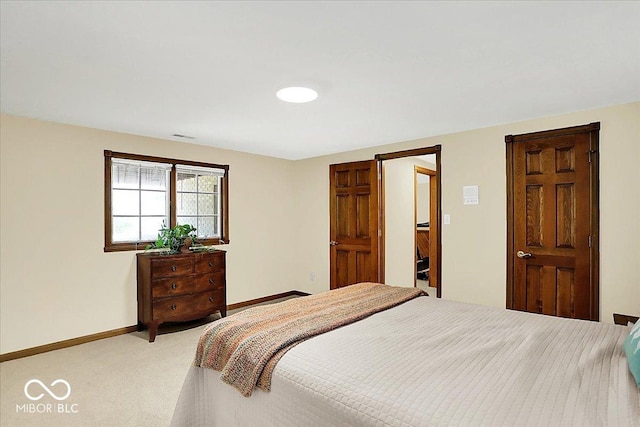 bedroom featuring baseboards, visible vents, and light carpet