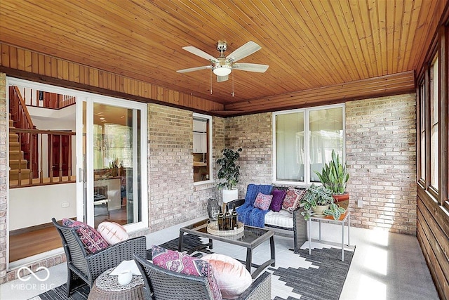 sunroom with ceiling fan and an outdoor living space