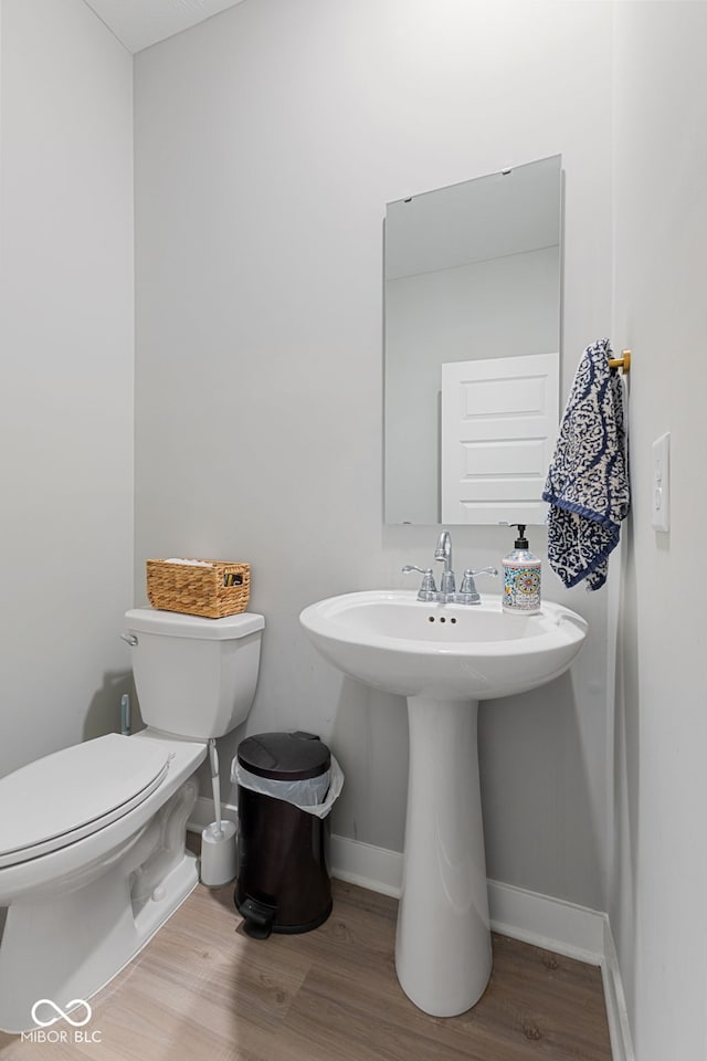 8673 Laurelton Pl, Brownsburg, IN 46112 - half bath featuring wood finished floors, toilet, and baseboards