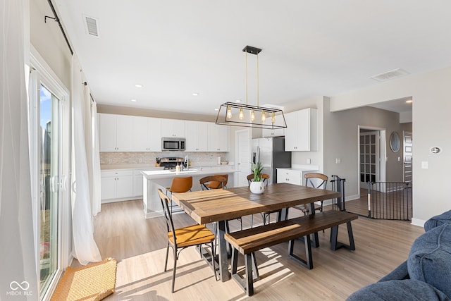 8673 Laurelton Pl, Brownsburg, IN 46112 - dining area with baseboards, visible vents, and light wood-style flooring