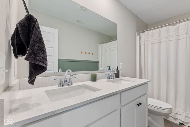 8673 Laurelton Pl, Brownsburg, IN 46112 - bathroom with double vanity, visible vents, toilet, and a sink