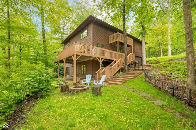13306 W 50 S, Columbus, IN 47201 - rear view of house with an outdoor fire pit, stairs, a wooden deck, a garage, and a patio area