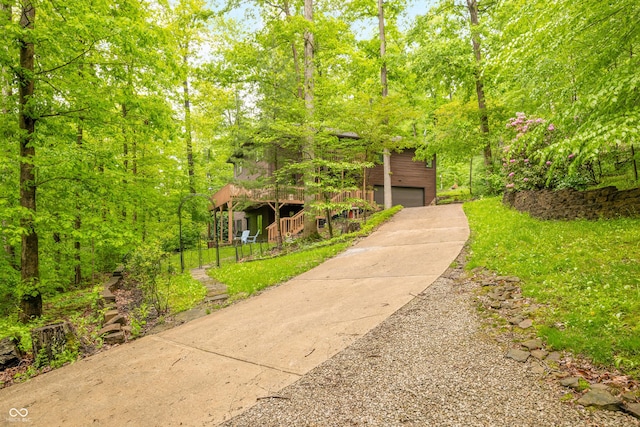 13306 W 50 S, Columbus, IN 47201 - view of front facade featuring stairs, a front lawn, concrete driveway, a garage, and a deck