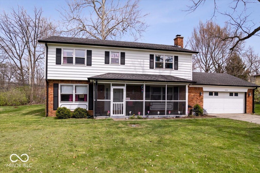 8180 E County Road 400 N, Brownsburg, IN 46112 - traditional-style home with concrete driveway, a sunroom, brick siding, and a garage