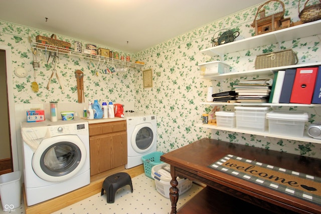 clothes washing area with independent washer and dryer and wallpapered walls