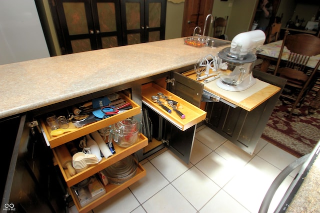 interior space with light countertops and light tile patterned floors