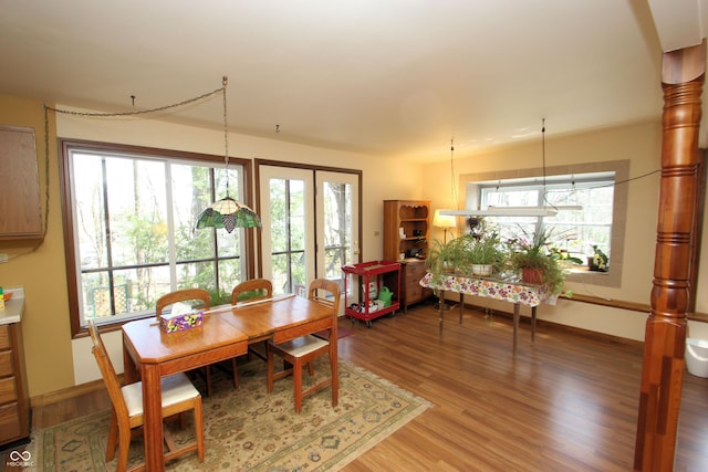 dining area with light wood finished floors and baseboards