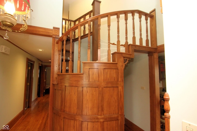 staircase featuring recessed lighting, baseboards, and wood finished floors