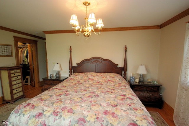bedroom with crown molding, a notable chandelier, a closet, and wood finished floors