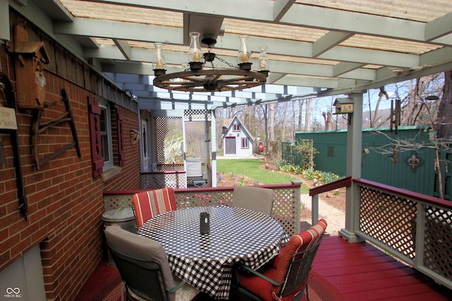 wooden deck featuring outdoor dining space and a ceiling fan