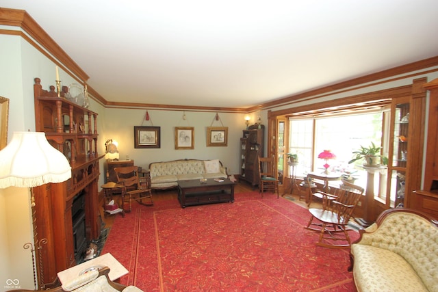 carpeted living room with a fireplace and crown molding